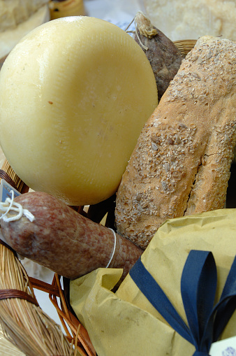 basket with different kinds of salami and cheese from Marche region as ciauscolo, lonza, pecorino and ascolana olives