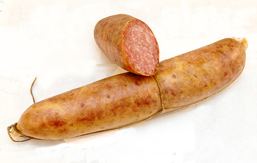 Ciauscolo is a spreadable salami sausage typical of the Marche region in Italy isolated on a white background
