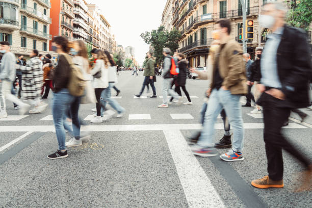 istock People wearing masks walking on zebra crossing 1315363938