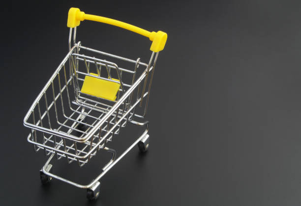 istock Shopping cart on black background with space for text 1315365310