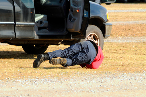 a stuntman performing a stunt, falling out of a moving car