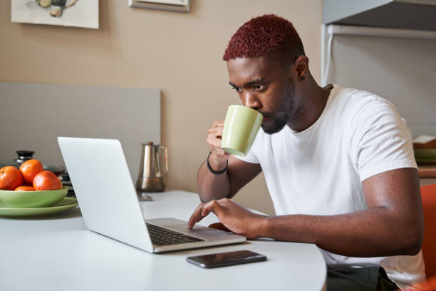 istock Man drinking his morning coffee while working at home during the self isolation 1315366393