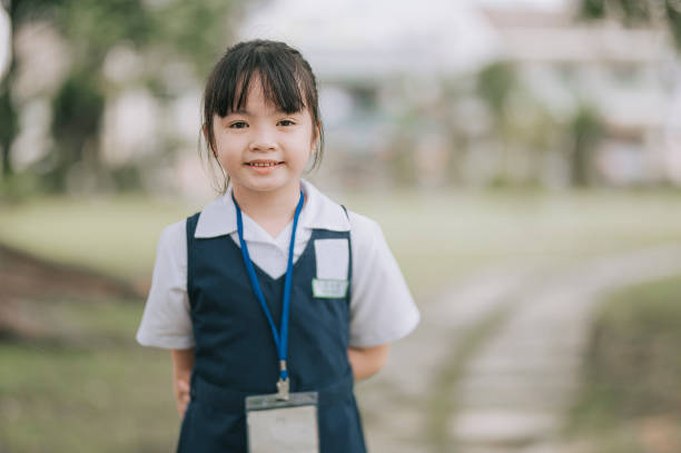 istock young girl Child with school uniform looking at camera smiling 1315367534