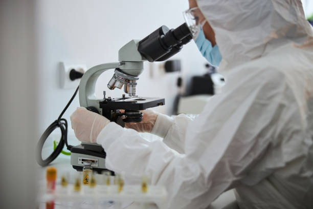 istock Lab technician examining an antiviral drug through the microscope 1315369480