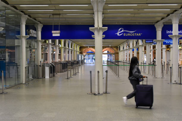 Empty check in desks at Eurostar international departures in St Pancras International Station A lady walks past empty check in desks at Eurostar international departures in St Pancras International Station during lockdown 2.0 Eurostar stock pictures, royalty-free photos & images