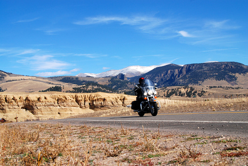 Creede, Colorado, 08/26/2008\nmotorcycle riding in the Rocky Mountains  with empty highway and scenic landscape