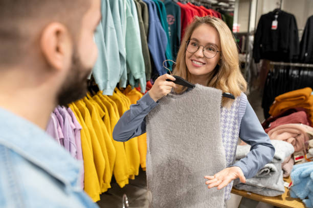 istock Young woman showing new pullover to her boyfriend 1315373184