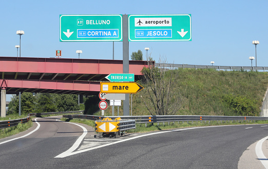 crossroads on the motorway with directions to reach the seaside resorts in Northern Italy  and text MARE that means SEA in Italian language