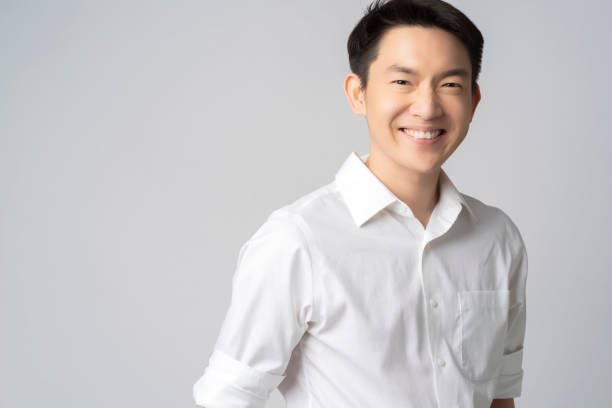 灰色の背景に隔離魅力的な若いアジアのビジネスマン白いシャツ半体のスタジオの肖像画 - シャツ ストックフォトと画像