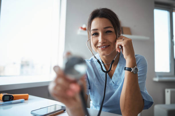 istock Cheerful female doctor using stethoscope in clinic 1315374900