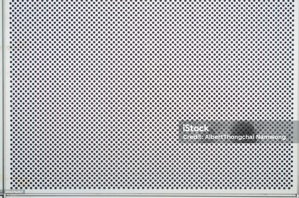 A hole on a white metal background Perforated Stock Photo