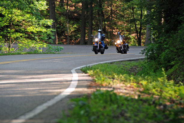 motorradfahren auf forststraße - curve driving winding road landscape stock-fotos und bilder