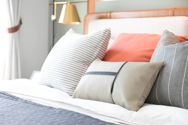 istock White and pastel orange design pillow in cozy bedroom. 1315380239