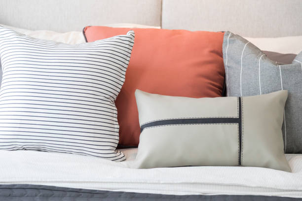 istock White and pastel orange design pillow in cozy bedroom. 1315380240