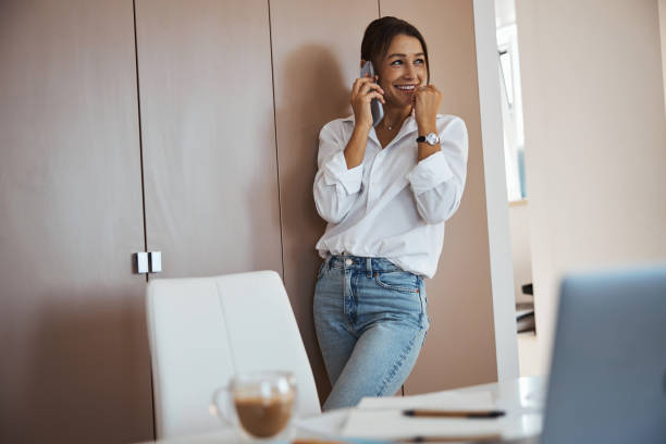 istock Beautiful joyful woman having phone conversation at work 1315382608