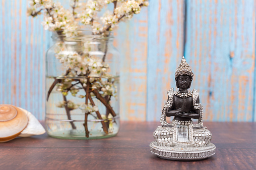 Buddha figure amid colorful spring flowers