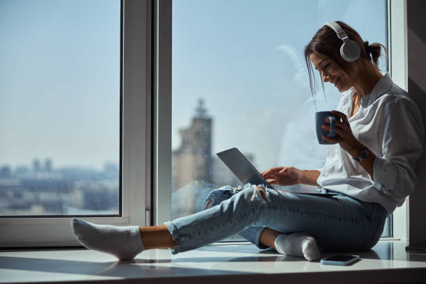 istock Charming woman in headphones using notebook at home 1315382664
