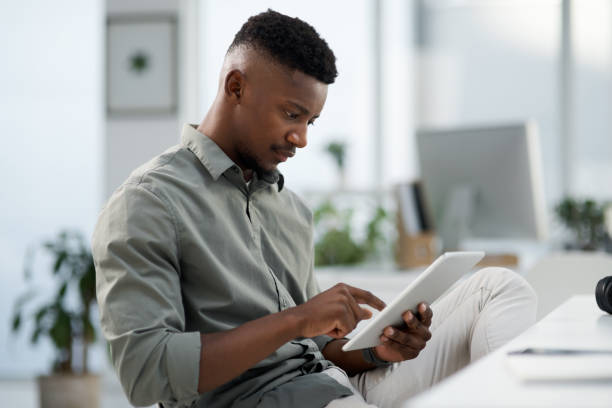 istock Shot of a young businessman working on a computer in an office 1315385412