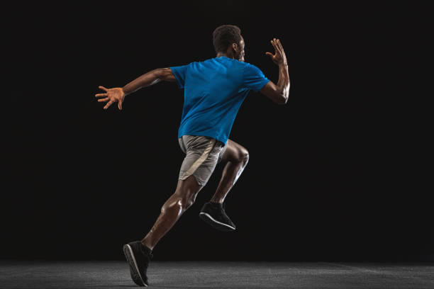 istock One African-American man, athlete training isolated over black background. 1315389030