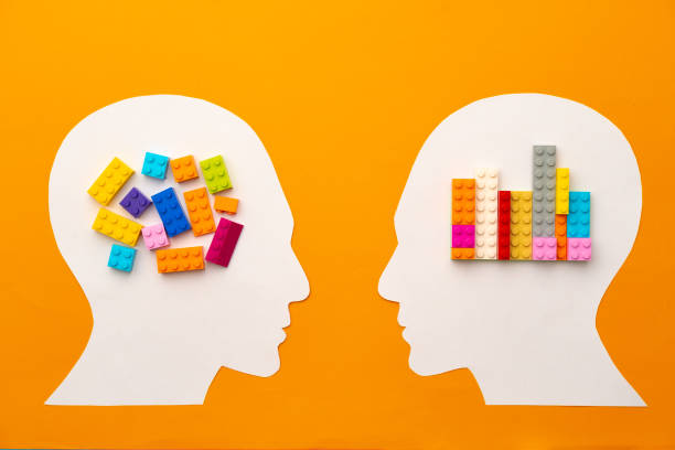 istock Papercut head silhouette with toy constructor pieces on yellow background 1315389298