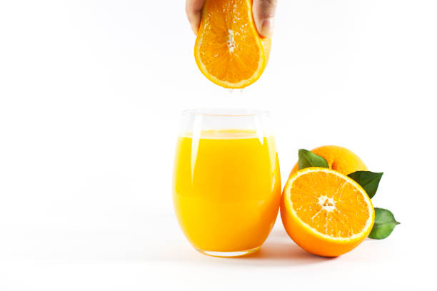 стакан свежего апельсинового сока с фруктами разрезать пополам и нарезать зеленым листом, изолированным на белом фоне, вырезая путь - isolated on white orange juice ripe leaf стоковые фото и изображения