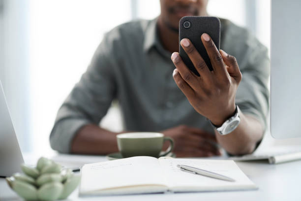 istock Cropped shot of a young man using his phone at work 1315393377