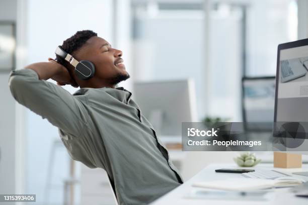 Shot Of A Young Man On A Call At Work In A Office Stock Photo - Download Image Now - Music, Relief - Emotion, Office