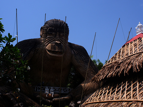 Bay, Laguna, Philippines - April 29, 2021: Cabana roof obscures the view of giant gorilla clay statue adorn the Isdaan Floating Restaurant in the countryside serving as the main tourist attraction.