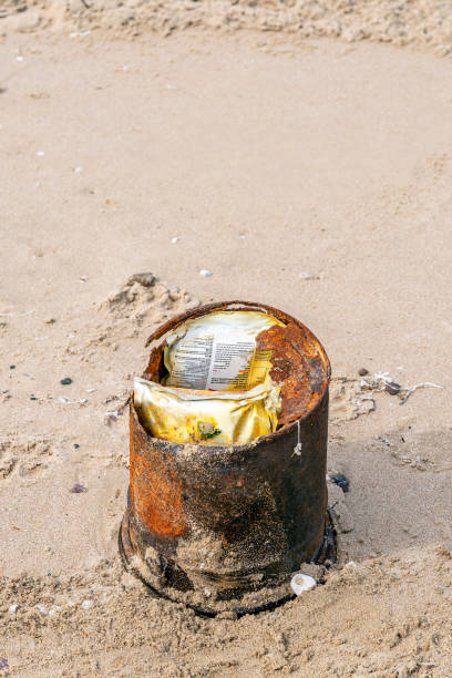 istock Garbage in rusty tin on the sand by the sea 1315396894