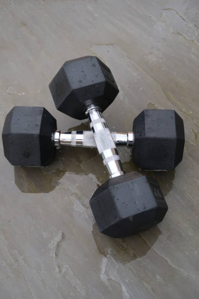 istock A pair of hexagonal dumbbells outdoors on a patio in the rain 1315397608