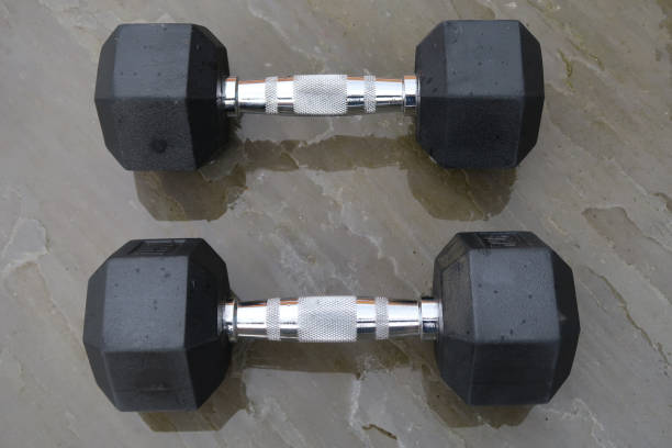 istock A pair of hexagonal dumbbells outdoors on a patio in the rain 1315397612