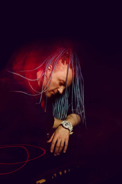 istock Handsome man with interesting braids on a black background, shot with mixed light 1315398528
