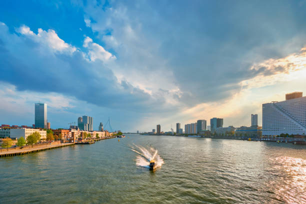 View of Rotterdam cityscape and Erasmus bridge over Nieuwe Maas with vessels and boats. Rotterdam, Netherlands