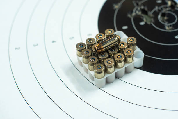 Detail - Close up of bullet cartridges over a target in a shooting club