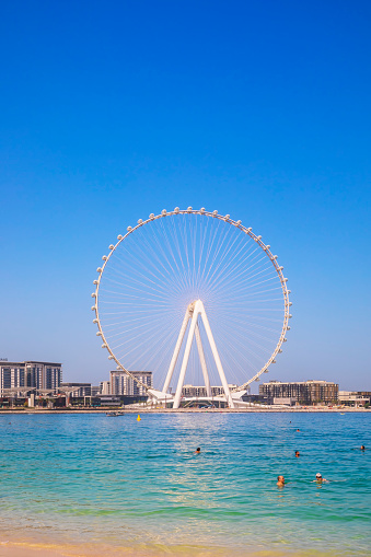 Dubai, UAE - March 04, 2021: Ferris wheel on Dubai Marina beach