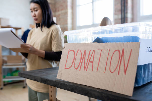 istock Plastic container with donation and young woman on background 1315406384