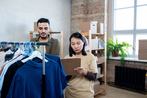 istock A man and a woman standing by rack with clothes 1315406434