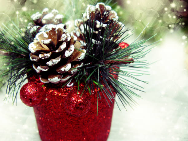 christmas background and cones decoration with fir branches snow on wooden board