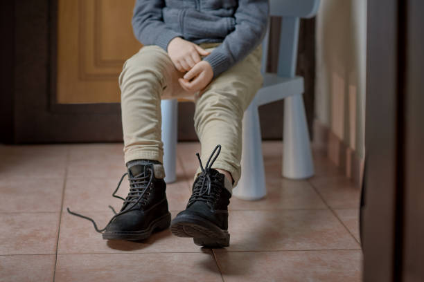 istock Child learning to tie shoelaces on boots before leaving home, selective focus 1315407304