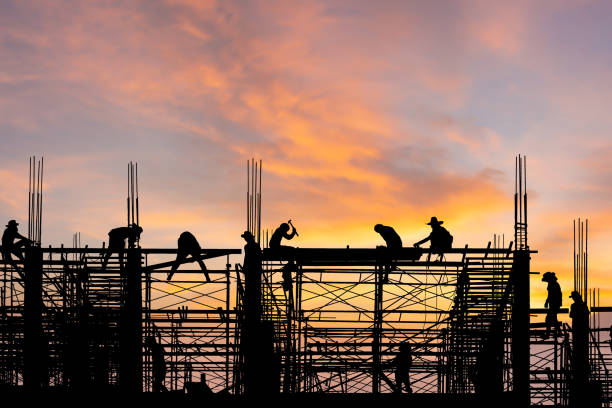 istock Silhouette of Engineer and worker on building site, constructing team working at site sunset in the evening time, Construction and teamwork concepts 1315407460
