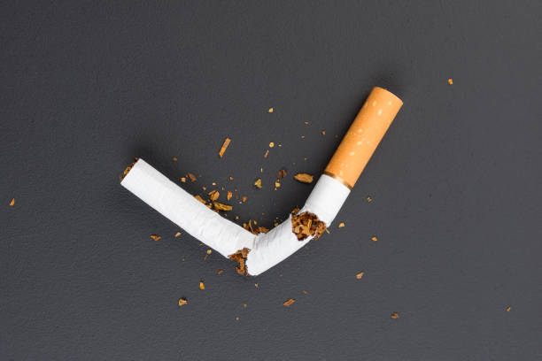 istock Broken cigarette with filter on black background. Concept of the problem of illness from smoking cigarettes. 1315409868