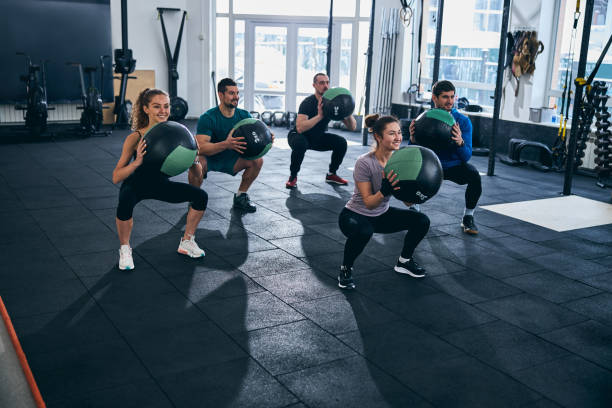 istock Young athletes doing squats at the gym 1315411328