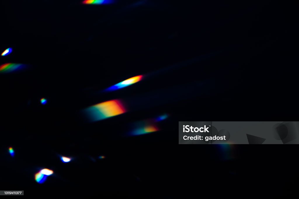colorful warm rainbow crystal light leaks on black background Blur colorful warm rainbow crystal light leaks on black background. Defocused abstract retro film analog effect for using over photos as overlay or screen filter Lens Flare Stock Photo