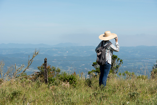 Image of a woman on a trail in the surroundings of the mountains of the Serra do Corvo Branco at the Serra Catarinense in Urubici, Santa Catarina state - Brazil