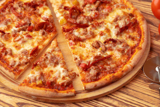 istock Freshly baked pizza on table close up 1315416375