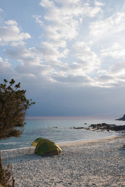 istock Vertical seascape with camping tent on the beach during sunset. 1315416666