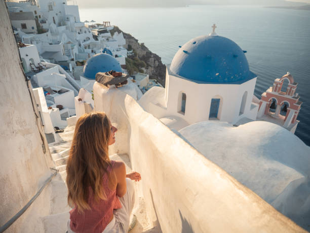 istock Woman contemplates Santorini from top, Greece 1315416957