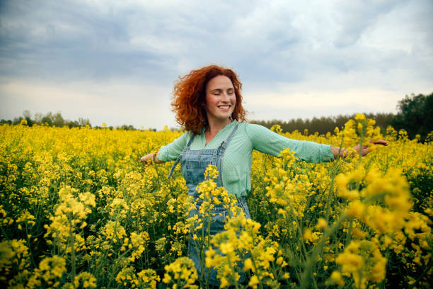 istock Cheerful woman in canola field 1315417169
