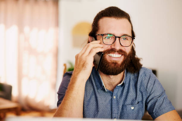 istock Shot of a young businessman using his smartphone while working from home 1315417440