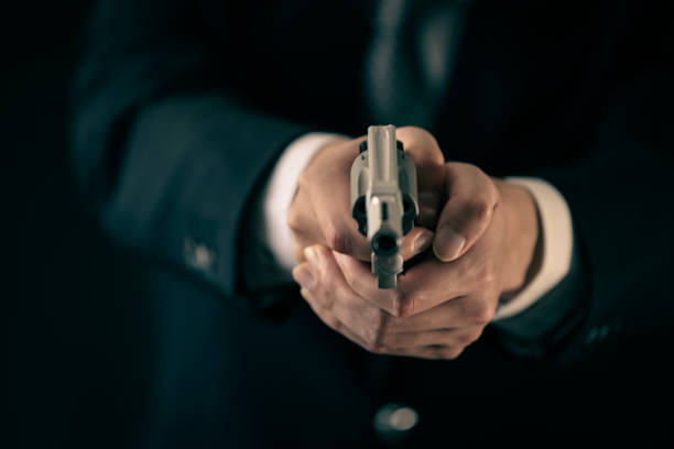 A man holding revolver pistol stock photo